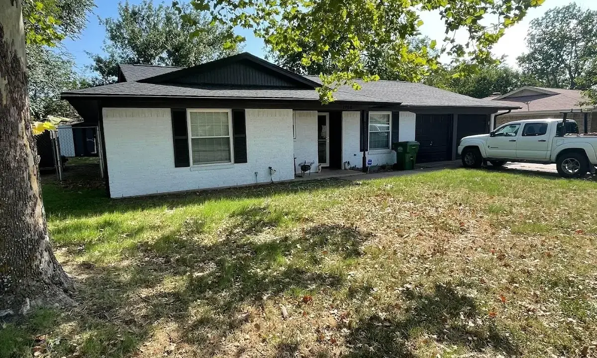 Professional roofing crew working on a residential roof in Tichigan